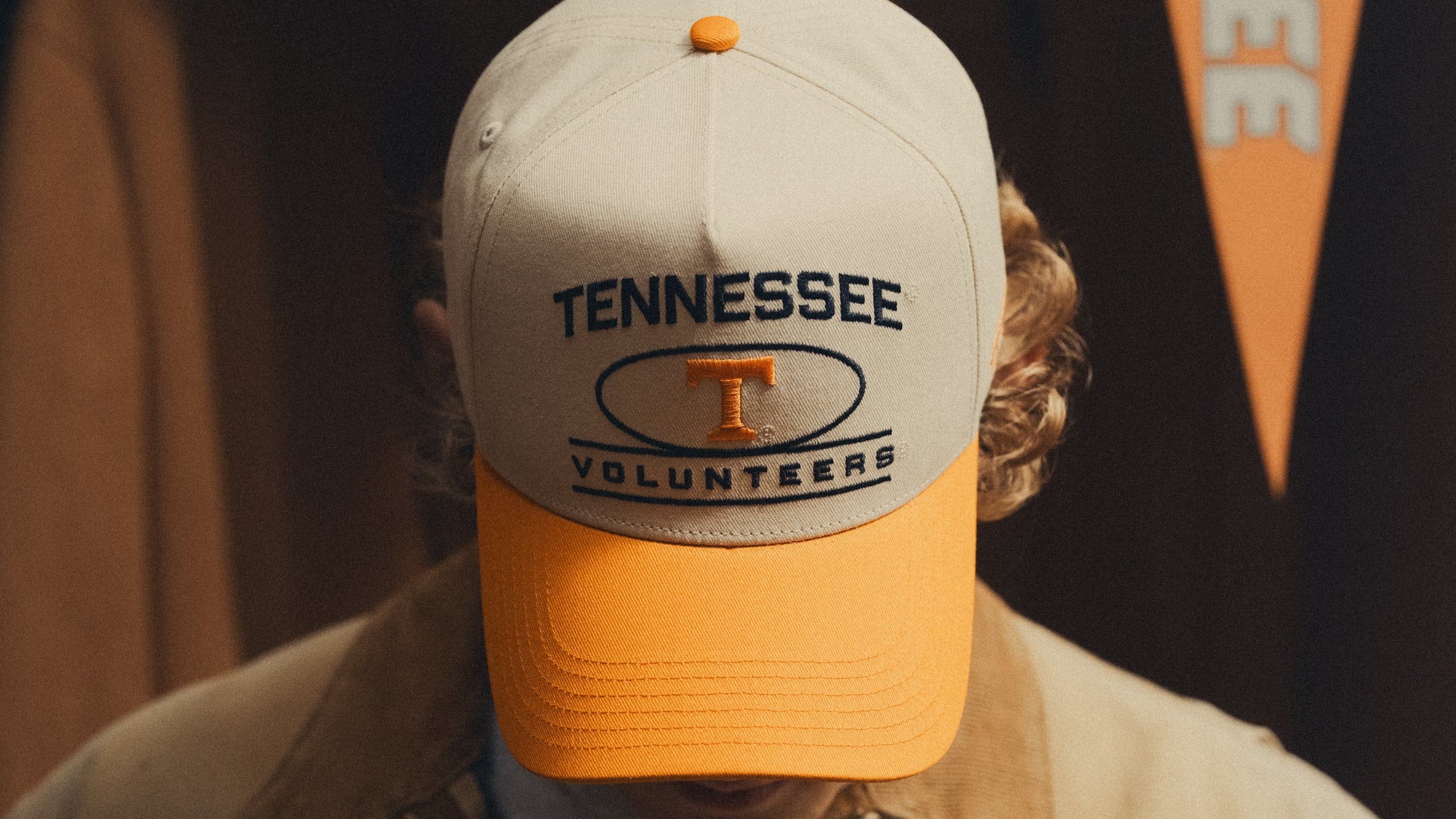 Person wearing a Tennessee Volunteers cap with a blurred background