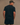 Close-up of model in Huega House Essential Tee in Black, brushed cotton with tonal Huega logo